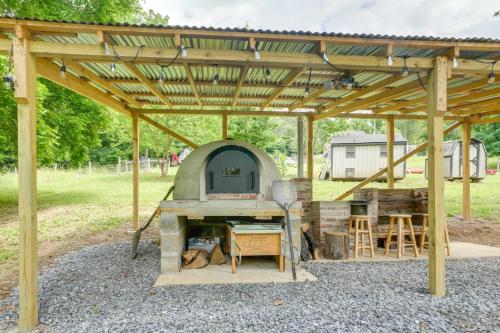 an outdoor kitchen under a wooden pergola at Front Royal Retreat on 3 Acres with Mtn Views! in Front Royal