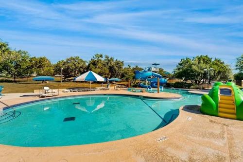 a swimming pool at a resort with a water slide at Lavish World of Tennis in Lakeway