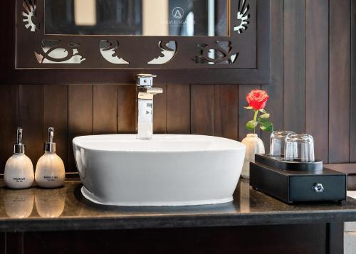 a white sink on a counter in a bathroom at Aqua Elegance Cruise by AHG in Ha Long