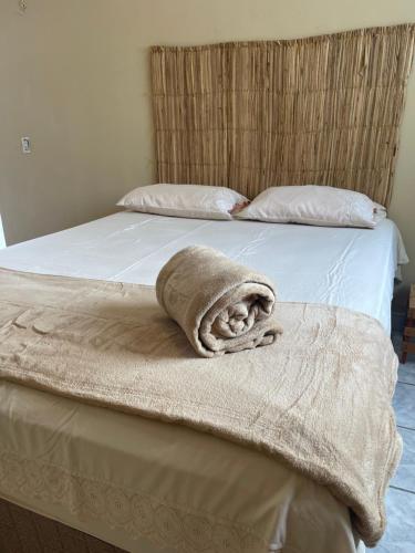 a bed with a blanket on the end of it at Hostel Wei in Boa Vista