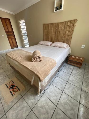 a bedroom with a bed with a blanket on it at Hostel Wei in Boa Vista