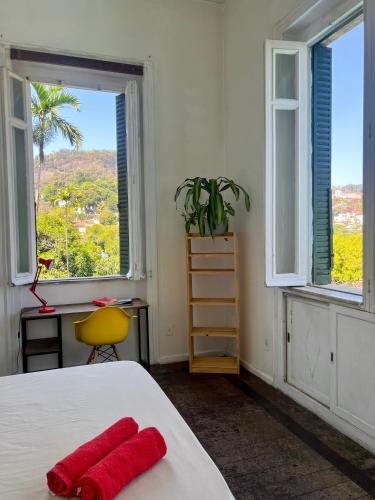 a bedroom with a bed with a red towel on it at Castelo dos Tucanos Host in Rio de Janeiro