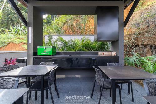 a restaurant with tables and chairs and a window at RUP - Studios Equipados em Prédio com Piscina in Blumenau