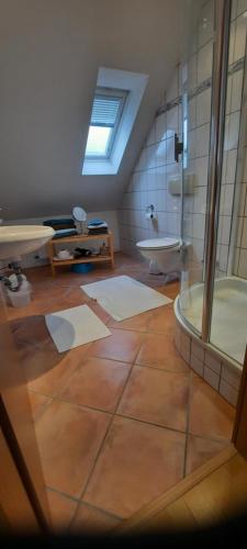 a bathroom with a shower and a sink and a tub at Hotel zur Brücke in Kevelaer