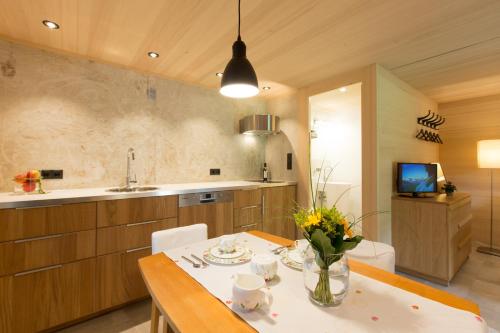 a kitchen with a table with flowers on it at Ferienloft Waldblick in Schwarzenberg