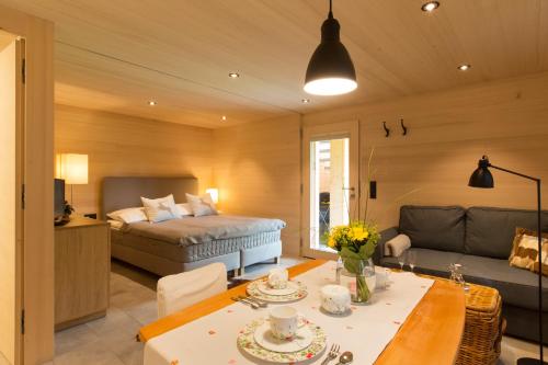 a living room with a bed and a table at Ferienloft Waldblick in Schwarzenberg