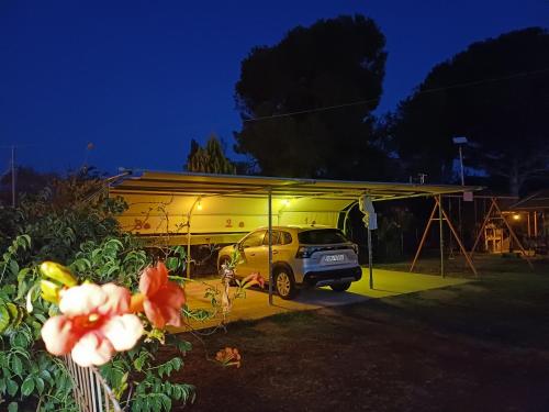 a car parked in front of a garage at night at Villa Angela in Sikia