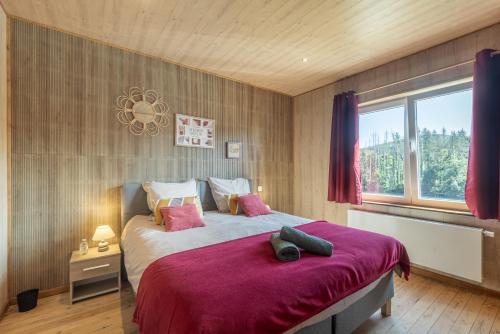 a bedroom with a large bed and a window at La Villa Wellness in Hastière-par-delà