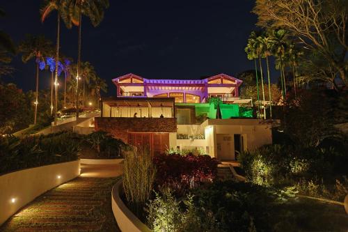 a house lit up at night with lights at Visus Hotel Boutique & Spa in Pereira