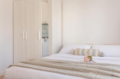 a white bedroom with a large white bed at Estudio Rosimar Light in L'Escala