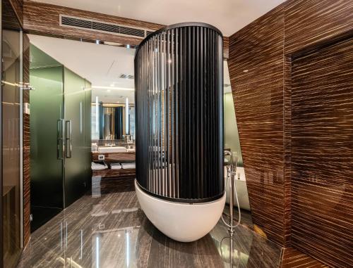 a bathroom with a large black and white tub at ROMEO Napoli in Naples