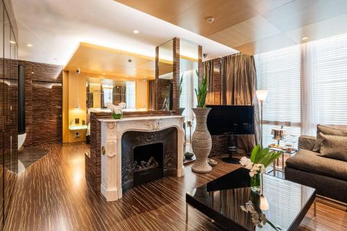 a living room with a fireplace and a couch at ROMEO Napoli in Naples