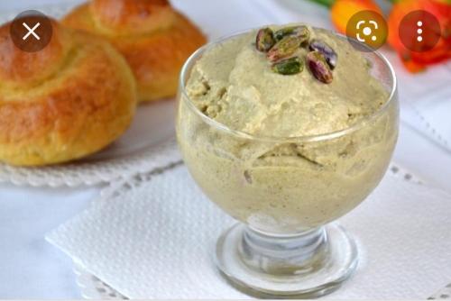 a glass bowl of dip on a napkin with donuts at Focu e Mari in Mascali