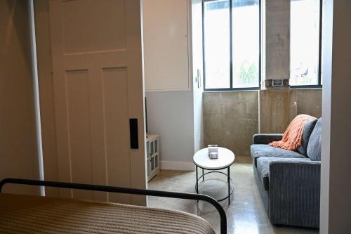 a living room with a couch and a table at Brand New Urban Loft Free Parking Close To Mayo in Rochester