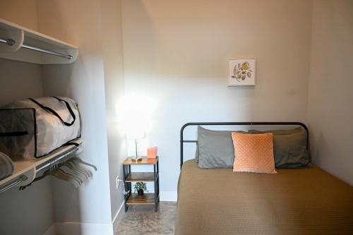 a small bedroom with a bed and a side table at Brand New Urban Loft Free Parking Close To Mayo in Rochester