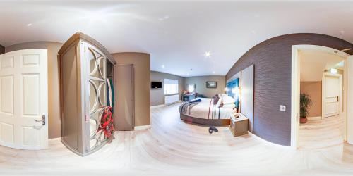 a bedroom with a bed and a room with a hallway at Robeen House in Killarney