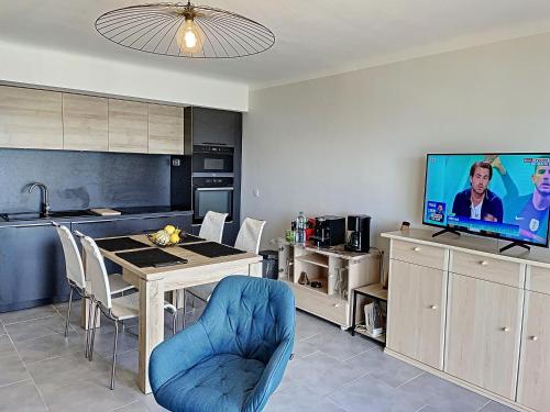 Il comprend une cuisine et une salle à manger avec une table et une télévision. dans l'établissement Vue mer panoramique 298L MAST, à Cannes