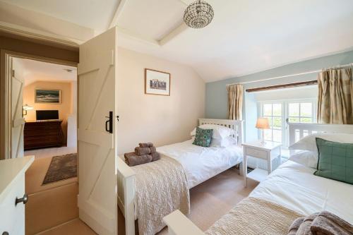 a bedroom with a bed and a couch at Strand Cottage in Burton Bradstock