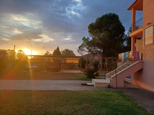 a sunset view of a house with a staircase at Villa Angela in Sikia