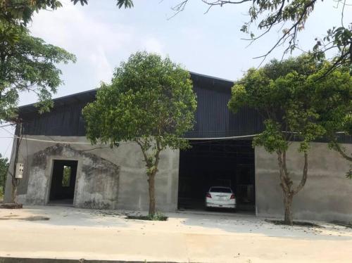 a car parked inside of a garage with two trees at Memory House in Phúc Yên