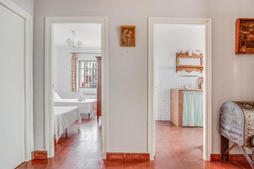 a hallway with two mirrors and a room with a bed at -Iponubahomes- Céntrica casa con jardín y chimenea in Baena