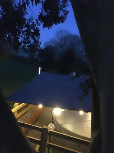 a view of a snow covered slope with lights at Shepherds Haven in Draycott in the Moors