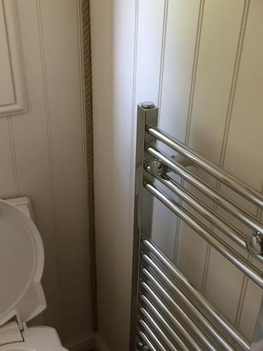 a bathroom with a refrigerator and a toilet at Shepherds Haven in Draycott in the Moors