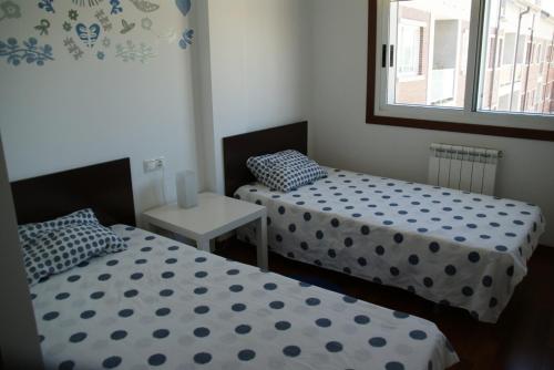 En eller flere senge i et værelse på Piso en el paseo marítimo de Cambados