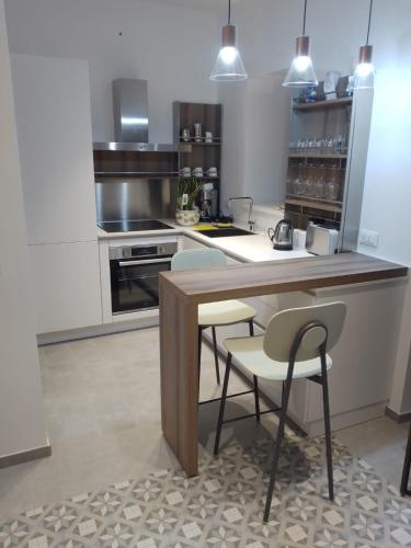 a kitchen with a table and some chairs in it at Dolce-Giardino in Isnello
