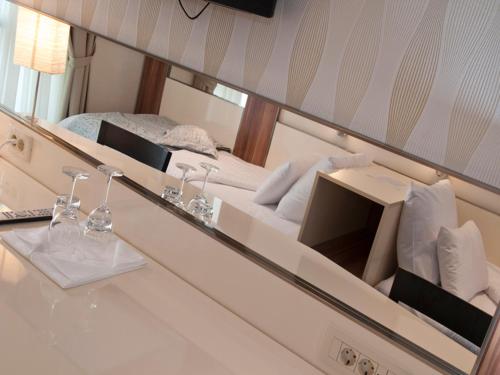 a reflection of a bed in a mirror at Hotel Lighthouse in Igalo