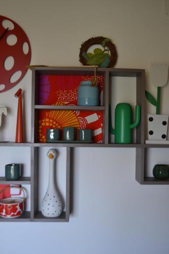 a shelf with cups and vases on a wall at Agriturismo Affaccio su Orvieto in Orvieto