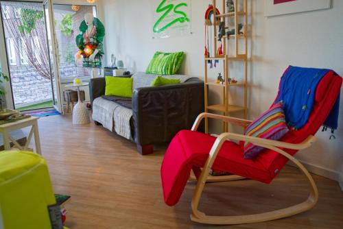 a living room with a chair and a couch at Ferienwohnung Little Dragon - Rheinblick in Rees