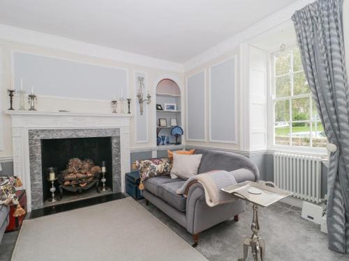 a living room with a couch and a fireplace at Humphreston House in Bristol