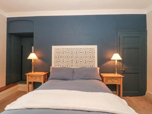 a bedroom with a bed with two nightstands and two lamps at Humphreston House in Bristol