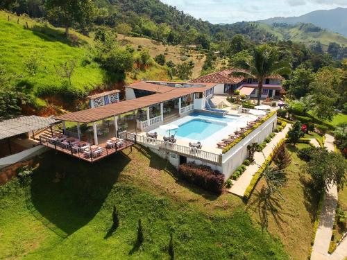 an aerial view of a house with a swimming pool at Hotel Jardín Del Río in El Bosque
