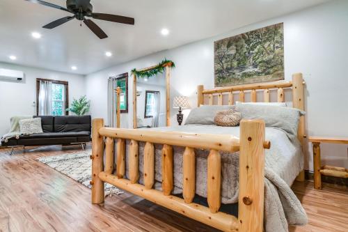 a bedroom with a wooden bed and a living room at Pet-Friendly Delta Cabin with Private Hot Tub! in Delta
