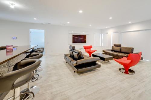 a waiting room with couches and chairs and a bar at Waterfront Evart Getaway with Fire Pit on 82 Acres! in Evart