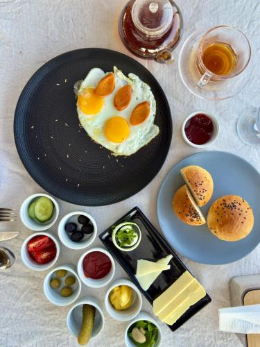 a table with a plate with an egg and some food at MareCoves Resort & Glamping in Cilangkahan