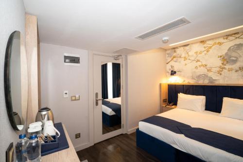 a hotel room with a bed and a bathroom at Querencia Hotel in Istanbul
