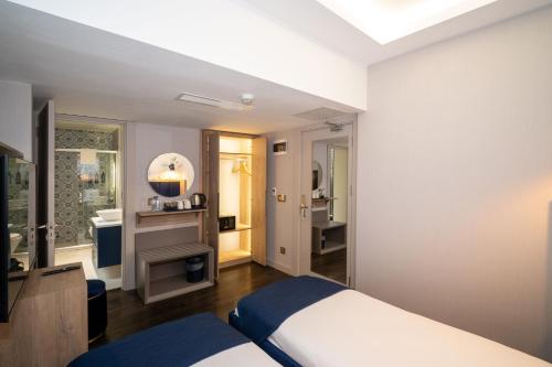 a bedroom with a bed and a bathroom at Querencia Hotel in Istanbul