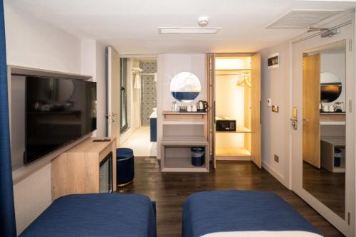 a room with two beds and a television at Querencia Hotel in Istanbul