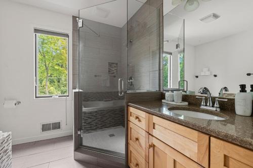 a bathroom with a shower and a sink and a tub at Living My Best Life in Union Pier
