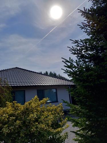 a house with the sun in the sky at Villa Vamus Vendég- és RendezvényHáz in Vámosszabadi