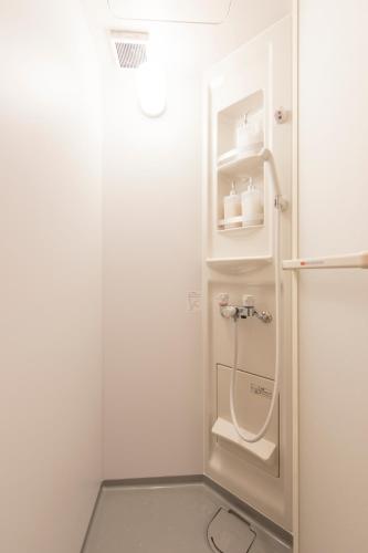 a bathroom with a shower with a toilet in it at GrapeHouse Koenji in Tokyo