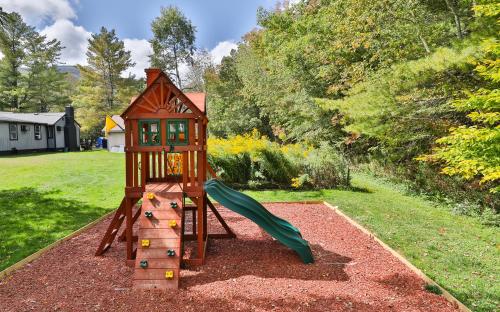 a small playground with a slide in a yard at Matterhorns Hunter Lodge in Hunter