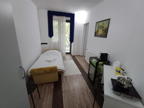 a small room with a bed and a window at Villa Vamus Vendég- és RendezvényHáz in Vámosszabadi