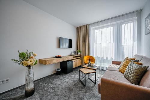 a living room with a couch and a table at PENZIÓN u JAKUBA & REŠTAURÁCIA Bezplatné Parkovanie in Martin
