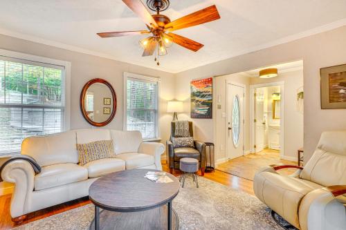 a living room with a couch and a ceiling fan at Mtn Views and Fire Pit Eureka Springs Home in Eureka Springs