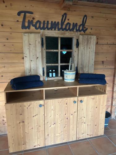 a room with a wooden wall with a sign on it at Wellnessalmhaus in Kloster