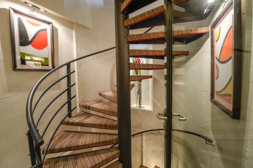 a spiral staircase in a house at Best Western Plus Hotel Sydney Opera in Paris